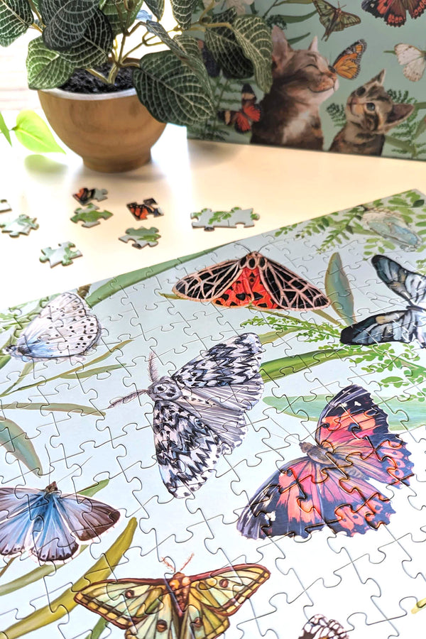 Side view of completed section of puzzle featuring illustrated butterflies.