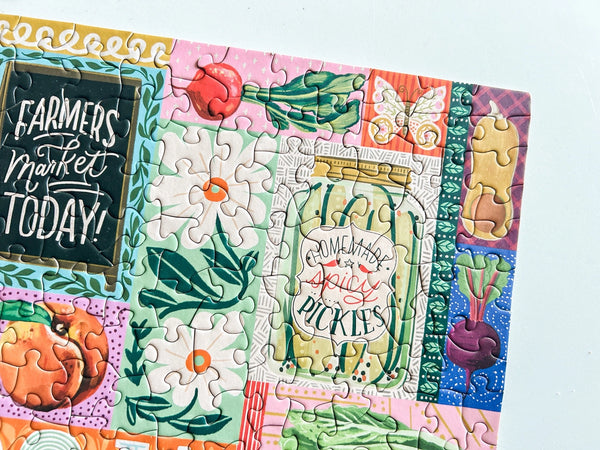 Colorful puzzle with illustrations of a farmers market theme on a light blue background