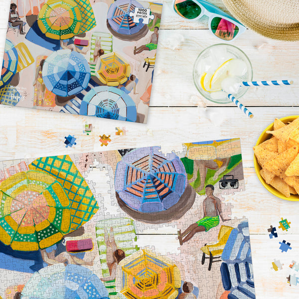 Top view of partially completed jigsaw puzzle featuring bright art of a beach scene with umbrellas.