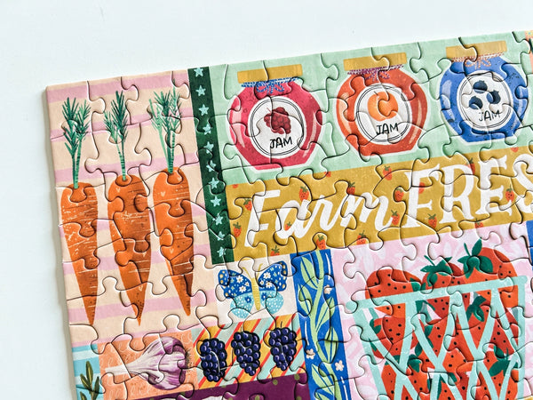Colorful puzzle with farmers market-themed design on a white background
