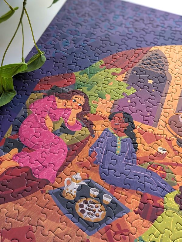 Close up of completed puzzle showing two women chatting with each other with drinks and snacks on a tray nearby.
