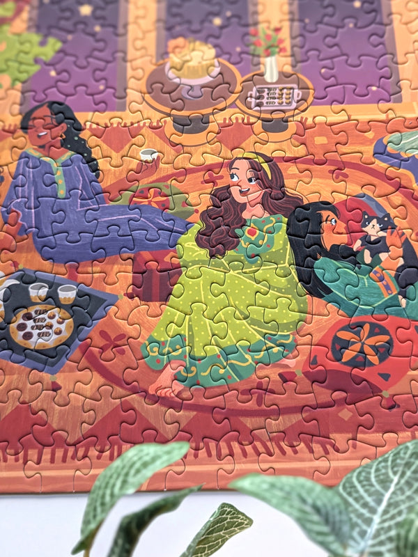 Close up detail of completed Girls Night puzzle showing three women, two chatting and one playing with a cat.
