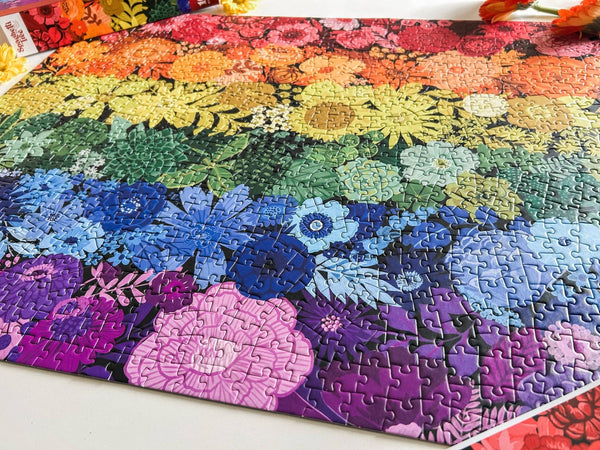 Colorful floral puzzle with a rainbow gradient on a white surface