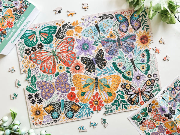 Butterfly-themed puzzle with completed pieces on a white surface