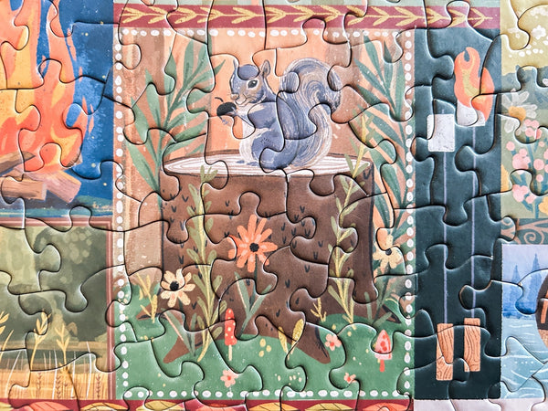 Close up of part of a jigsaw puzzle showing a squirrel on a tree stump in a forest setting