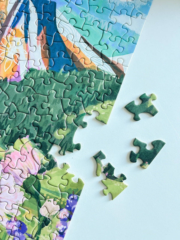 Partial puzzle with a scenic design on a light blue background