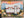 Close up of a completed puzzle section with a camper scene in a nature setting