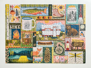 Completed 1000-piece jigsaw puzzle by Spaghetti Tree, featuring a colorful collage of outdoor camping and nature illustrations, photographed on a white surface.