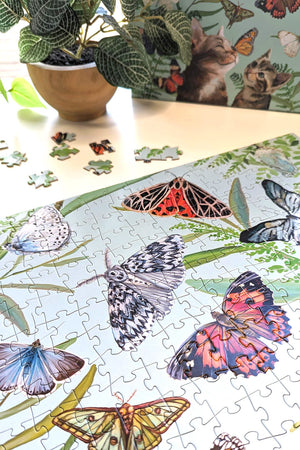 Side view of completed section of puzzle featuring illustrated butterflies.