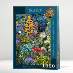 Jigsaw puzzle box with artwork showing birds tucked among a vibrant garden of succulents and flowers. Shown on a white background