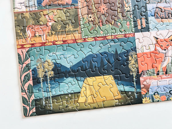 Partial puzzle with a scenic camping design on a white background