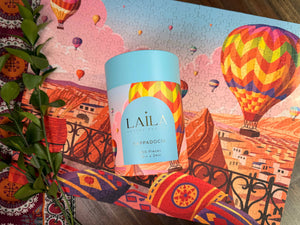 Laila product packaging with puzzle showing colorful hot air balloons and a scenic background