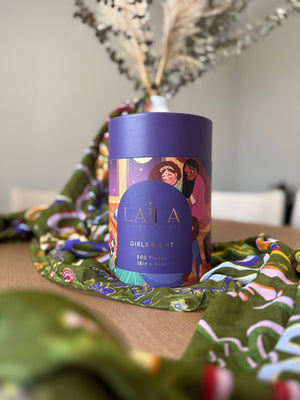 Laila Luxury Puzzle box on a decorative scarf with a dried florals and feathers in a vase in the background
