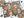 A Halloween-themed jigsaw puzzle with colorful skull, pumpkin, snake, candle, and butterfly illustrations, shown partially assembled on a white surface with loose puzzle pieces and the puzzle box around it.