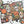 A Halloween-themed jigsaw puzzle with colorful skull, pumpkin, snake, candle, and butterfly illustrations, shown partially assembled on a white surface with loose puzzle pieces and the puzzle box around it.