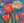 Colorful painting of flowers including tulips and daisies on a blue background