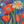 Colorful painting of flowers including tulips and daisies on a blue background