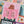 Jigsaw puzzle with a colorful design of a person holding a book in front of their face. 