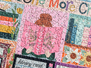 Jigsaw puzzle with a colorful design of a person holding a book in front of their face. 