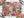 A Halloween puzzle viewed top down, surrounded by the box lid, black stick bundles, a print of the puzzle image and a few scattered pieces.