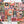 A Halloween puzzle viewed top down, surrounded by the box lid, black stick bundles, a print of the puzzle image and a few scattered pieces.