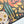A close-up of a completed jigsaw puzzle featuring a colorful Halloween design on a dark background, with a white surface visible along the bottom right corner.