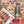 The back of a puzzle box atop a completed version of the puzzle showing halloween-themed artwork arranged in a grid collage.