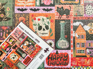The back of a puzzle box atop a completed version of the puzzle showing halloween-themed artwork arranged in a grid collage.