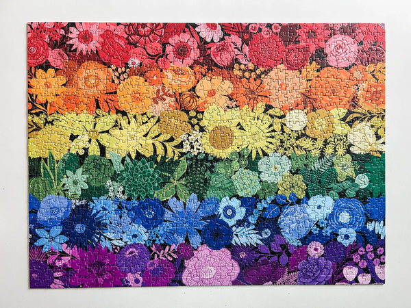 Colorful floral puzzle with a rainbow gradient on a white background