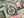 Close-up of a camping themed puzzle with a compass piece and decorative elements.