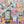 Colorful puzzle with a box and a completed puzzle featuring various book-themed scenes.