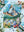 Jigsaw puzzle with art of a floral meadow and lake in front of the Matterhorn on a white surface with flowers around.