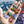 Colorful puzzle pieces held in a hand with a partially completed puzzle in the background.