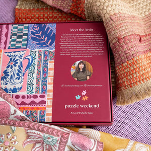 Puzzle box with colorful patterns and text about the artist Charlie Taylor on a textured fabric background