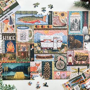 Jigsaw puzzle with camping and nature-themed images on a white surface