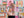 Hand holding colorful puzzle pieces with a blurred background of a puzzle