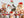 A photo of the puzzle Festive Cat Bunch which shows 5 cats surrounded by holiday garlands and bows against a lightly striped background.