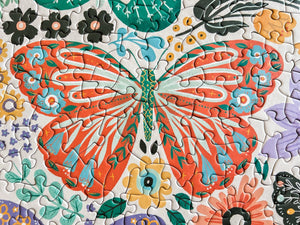 Colorful butterfly puzzle with flowers on a white background