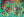 Image of the artwork of the puzzle 'Sky Nests' showing whimsical bird houses atop a green-blue patterned background with birds, flowers and butterflies. 