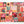 A complete jigsaw puzzle with a grid collection of art featuring autumn and Thanksgiving motifs, including pumpkins, turkeys, sunflowers, plaid patterns, acorns, and seasonal phrases like 'Sweater Weather' and 'Farm Fresh Pumpkins,' shown against a plain white background.