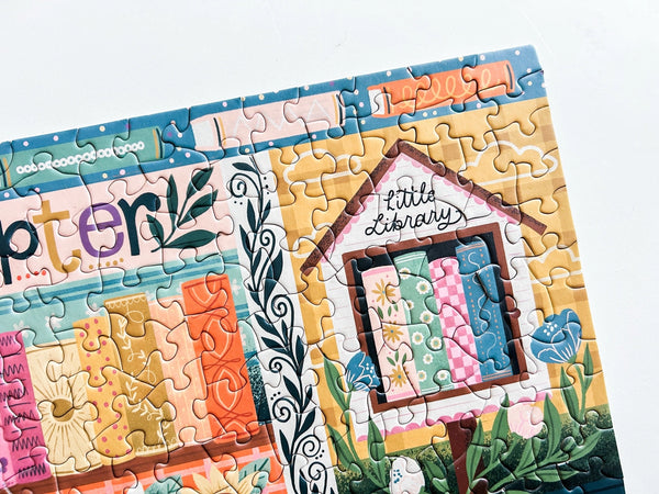 Jigsaw puzzle with a colorful design of a 'Little Library' house on a white background