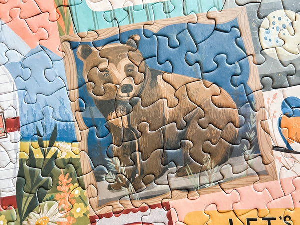 Close up of nature themed jigsaw puzzle showing a bear design section
