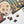A partially assembled jigsaw puzzle featuring a colorful sugar skull and Halloween-themed illustrations on a dark background, with a few loose puzzle pieces on a white surface and a black spider decoration in the corner.