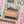 Partial puzzle with colorful design featuring a book stack and plants.