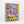 Photo of an angled jigsaw puzzle box against a white surface/wall. Box shows an illustration of a busy urban scene with many people and figures, including animal people going about their lives. 