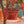 Colorful puzzle with potted plants and a hand holding a branch.