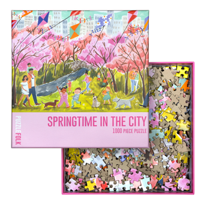 Puzzle box titled 'Springtime in the City' with a colorful illustration of people in a park.