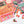 A colorful jigsaw puzzle with illustrated panels and the words 'SWEATER WEATHER' on an orange section, shown partially assembled on a white surface with a few loose puzzle pieces nearby.