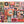 A jigsaw puzzle featuring a colorful, patchwork-style Halloween collage with various illustrated motifs including jack-o'-lanterns, a witch's hat, a skull, a haunted house, a potion bottle labeled 'Elixir', bats, pumpkins, and the words 'Trick or Treat' and 'Happy Halloween'.