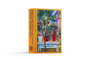 Puzzle box with artwork of plants and a colorful background